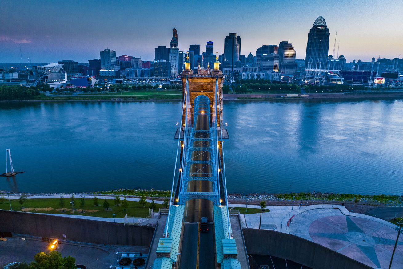 Aerial view of Suspension Bridges and James Roebling Bridge crossing Ohio River from Covington Kentucky to Cincinnati, Ohio