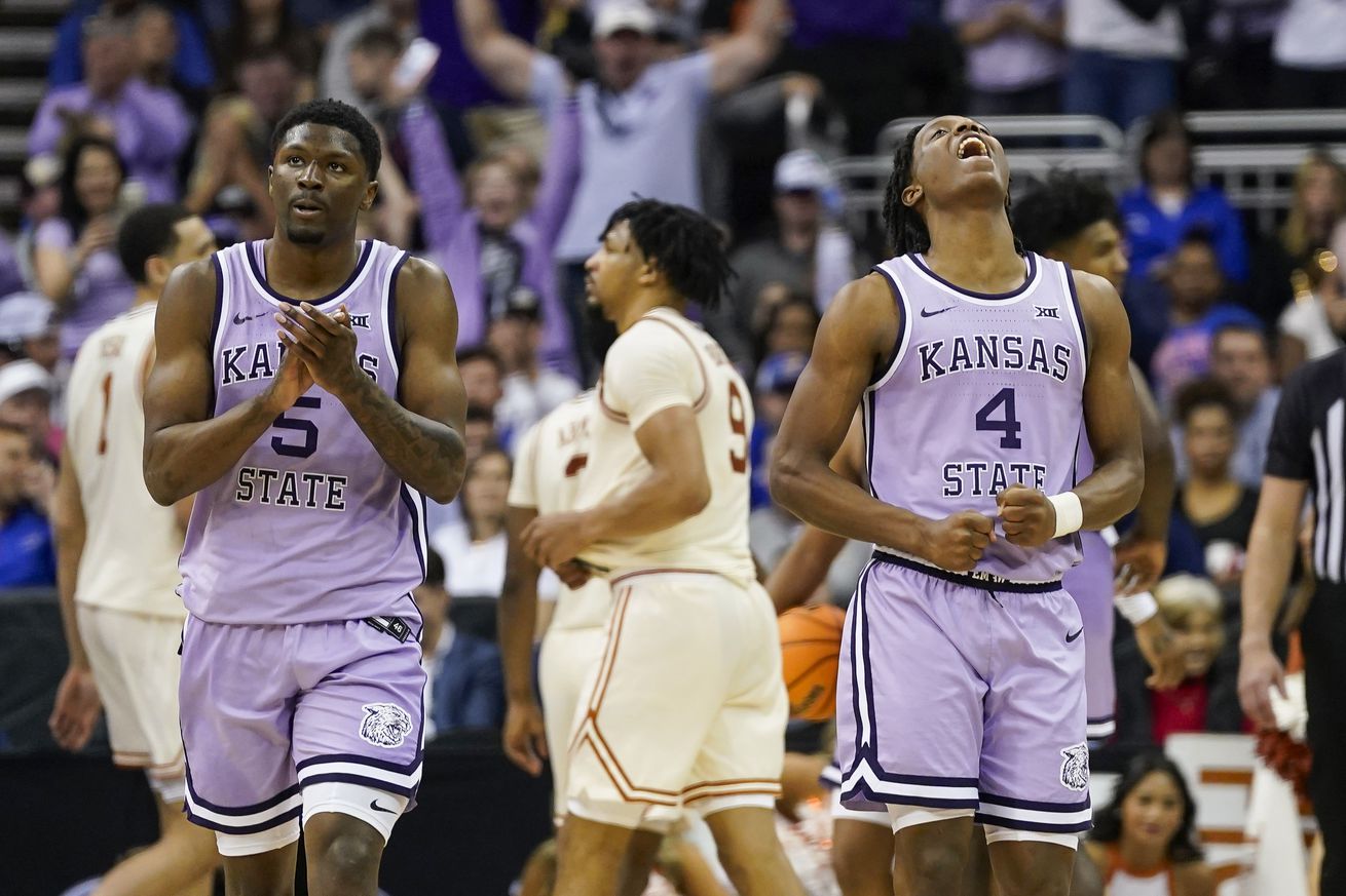 Cam Carter #5 and Dai Dai Ames #4 of the Kansas State Wildcats celebrate after defeating the Texas Longhorns in the second round of the Big 12 Men’s Basketball Tournament at T-Mobile Center on March 13, 2024 in Kansas City, Missouri.