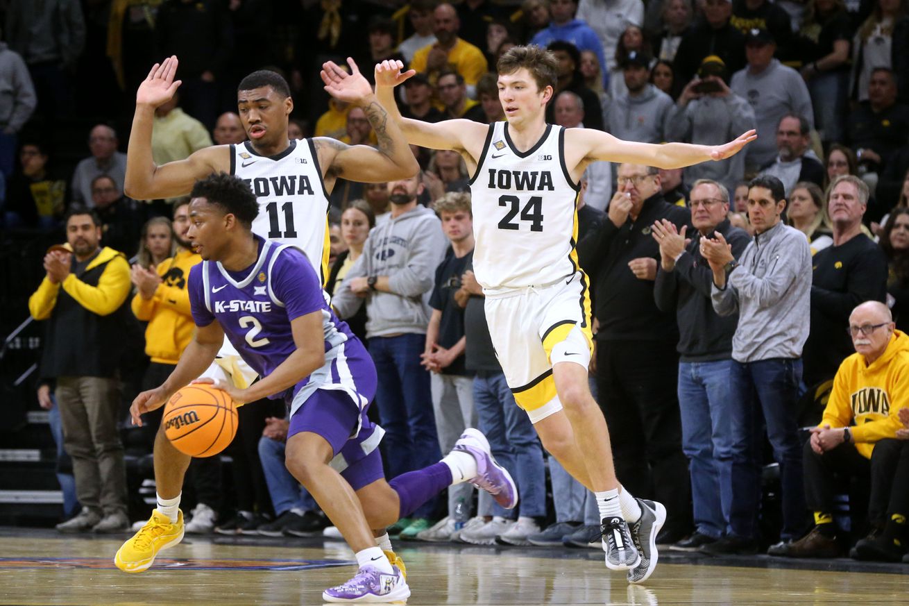 Iowa s Tony Perkins (11) and Pryce Sandfort (24) defend Kansas State s Tylor Perry (2) in a first-round NIT game Tuesday, March 19, 2024 at Carver-Hawkeye Arena in Iowa City, Iowa.