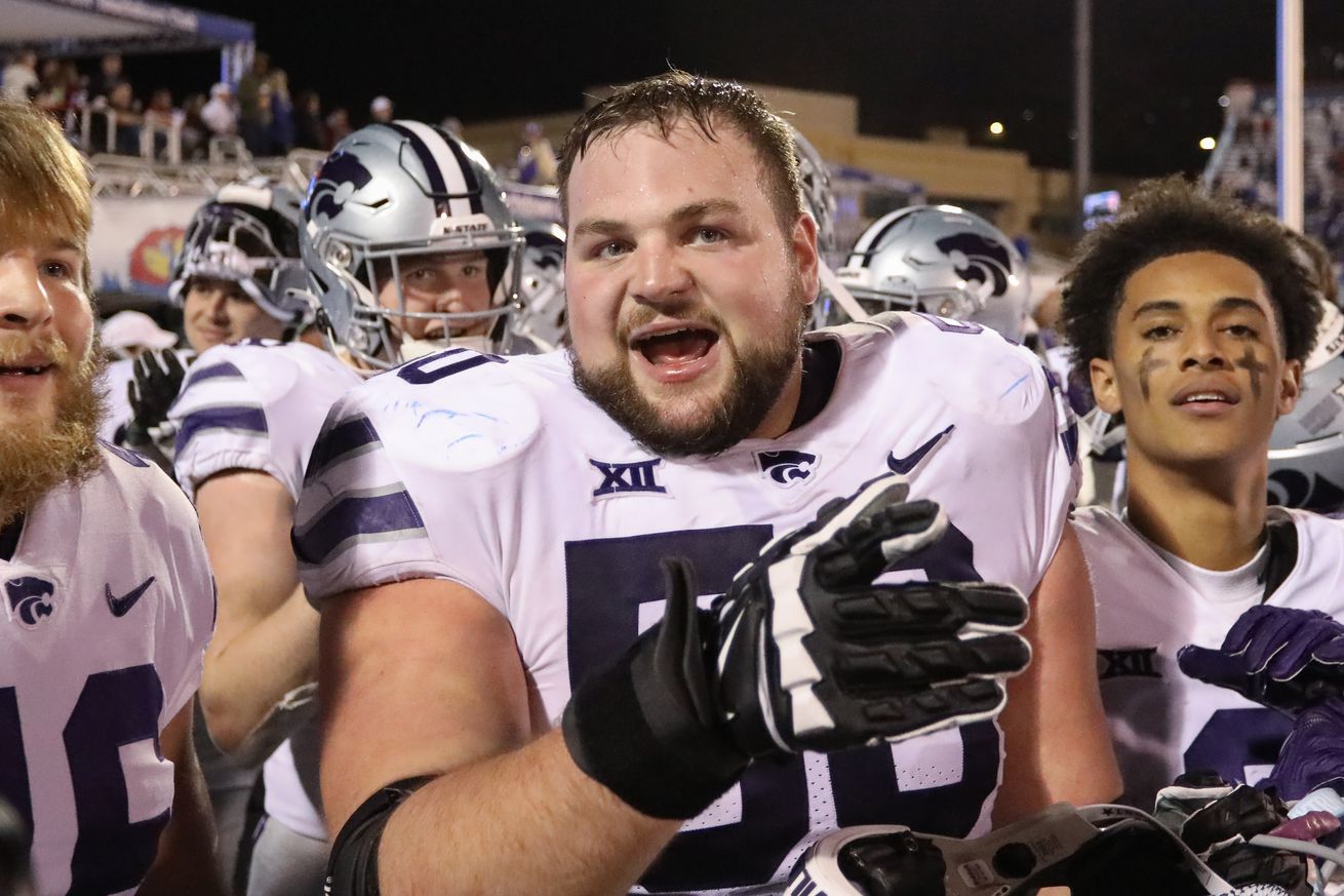 LAWRENCE, KS - NOVEMBER 18: Kansas State Wildcats offensive lineman Cooper Beebe (50) celebrates with teammates after a Big 12 football game between the Kansas State Wildcats and Kansas Jayhawks on Nov 18, 2023 at Memorial Stadium in Lawrence, KS.