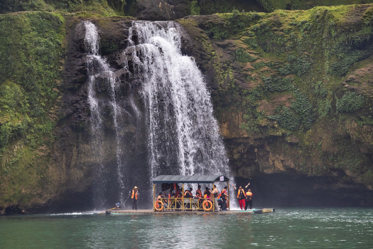 Tourists Enjoy Spring Scenery Of Detian Transnational Waterfall In Guangxi