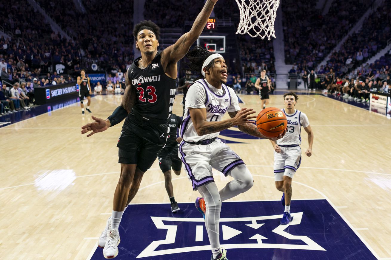 Background: Dec 30, 2024; Manhattan, Kansas, USA; Kansas State Wildcats guard Dug McDaniel (0) shoots against Cincinnati Bearcats forward Dillon Mitchell (23) during the second half at Bramlage Coliseum. Mandatory Credit: Jay Biggerstaff-Imagn Images