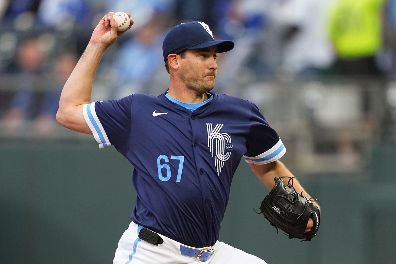 Seth Lugo raises his right arm before throwing a pitch.