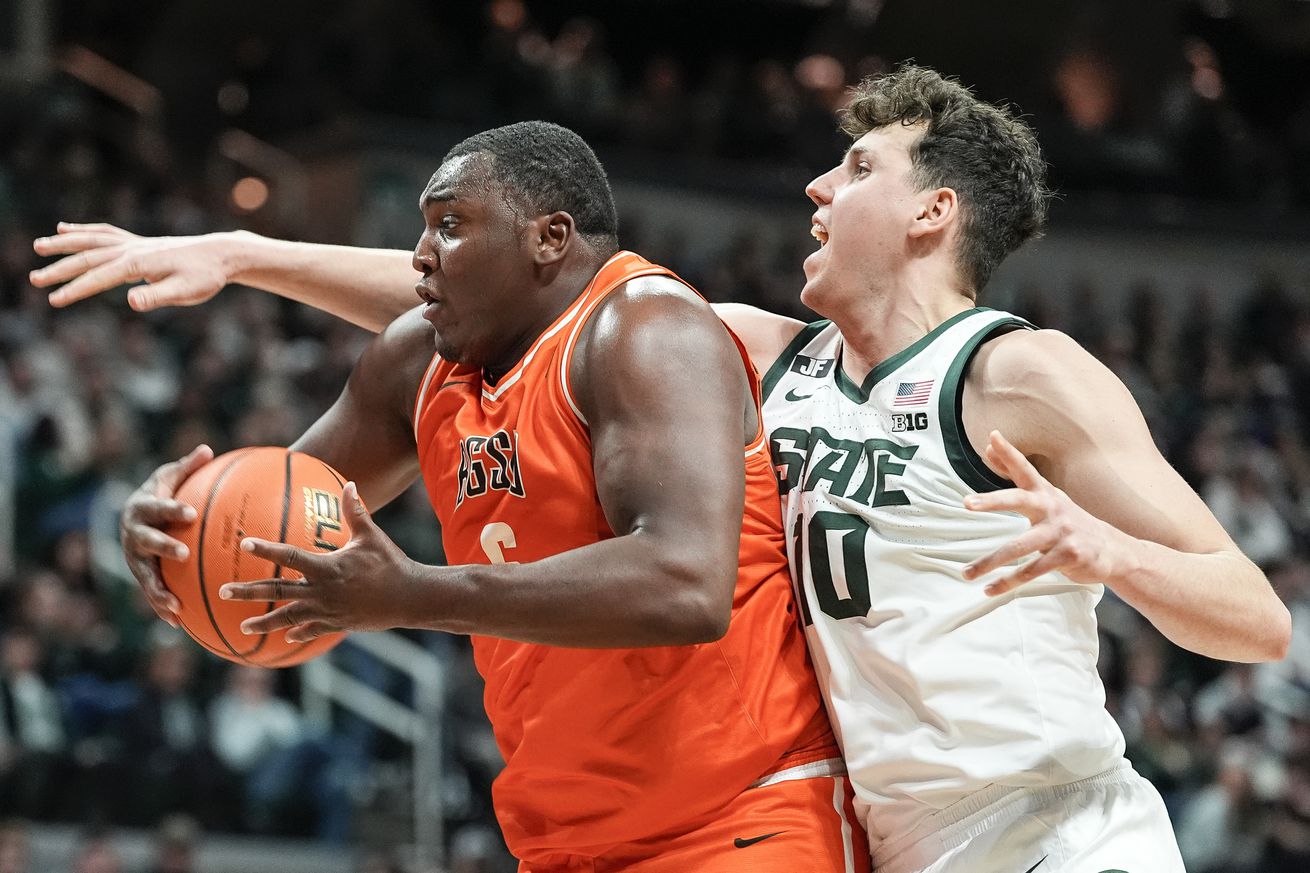 Nov 16, 2024; East Lansing, Michigan, USA; Bowling Green Falcons forward Marcus Johnson (6) grabs a rebound against Michigan State Spartans center Szymon Zapala (10) during the first half at Breslin Center.