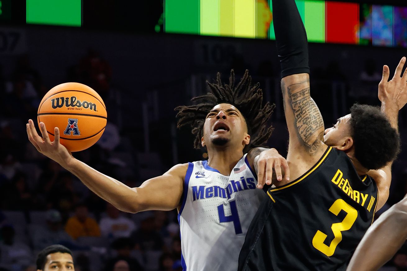 Mar 14, 2025; Fort Worth, TX, USA; Memphis Tigers guard PJ Haggerty (4) scores a layup against Wichita State Shockers forward Ronnie DeGray III (3) during the second half at Dickies Arena.