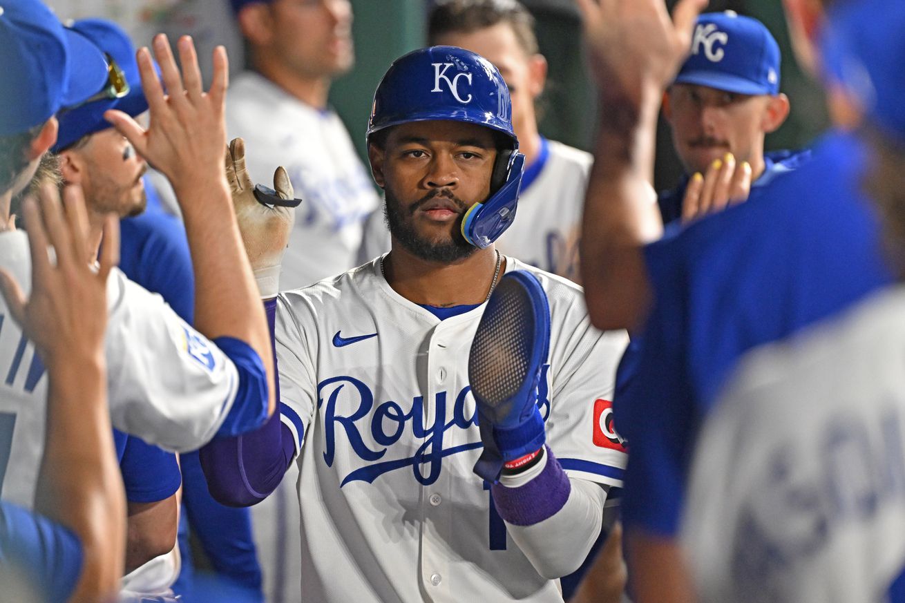 Kansas City, Missouri, USA; Kansas City Royals third baseman Maikel Garcia (11) celebrates in the dugout after scoring a run in the eighth inning against the Chicago White Sox at Kauffman Stadium.