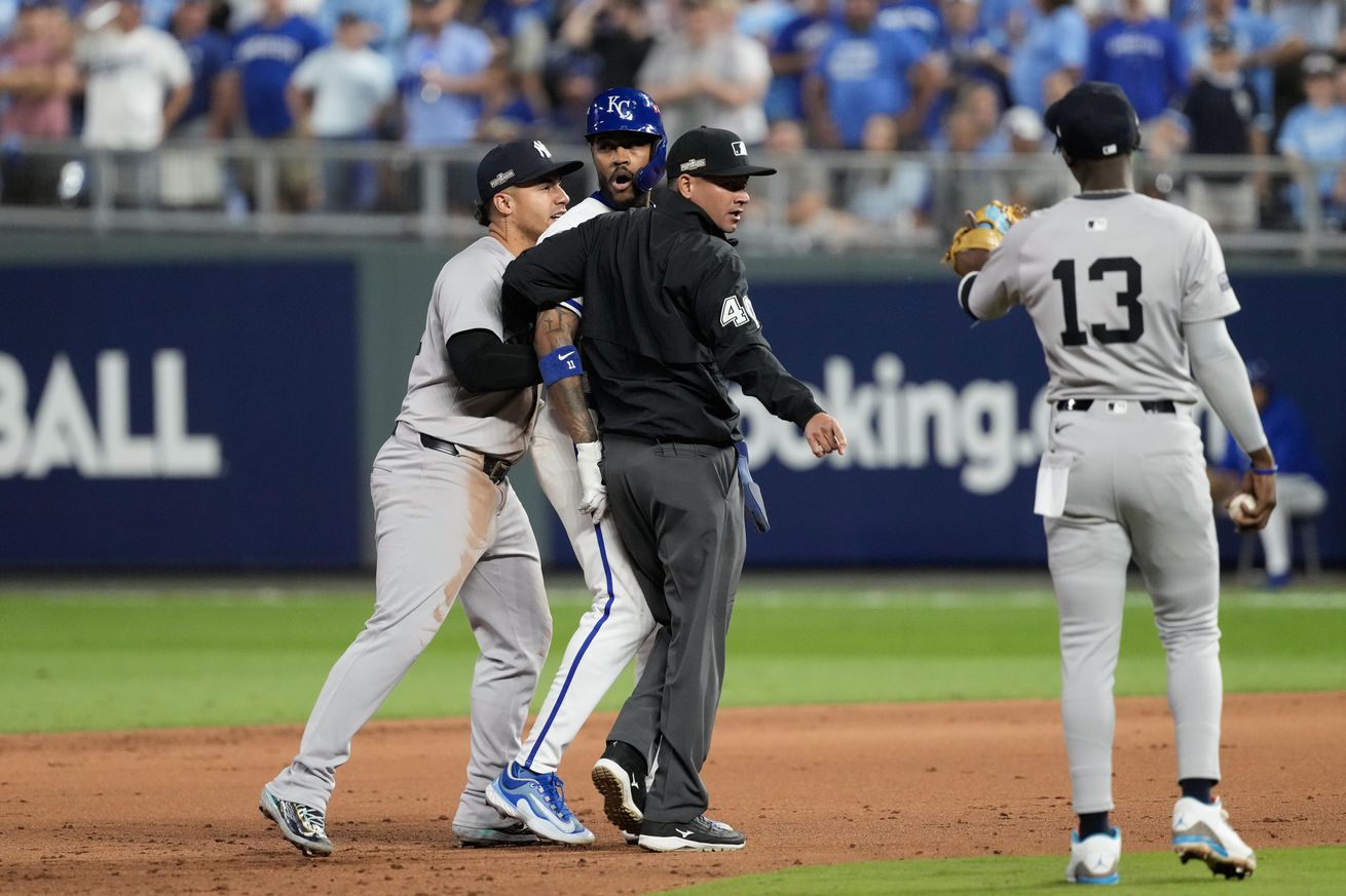 Maikel Garcia #11 of the Kansas City Royals and Jazz Chisholm Jr. #13 of the New York Yankees exchange words during the sixth inning during Game Four of the Division Series at Kauffman Stadium on October 10, 2024 in Kansas City, Missouri.