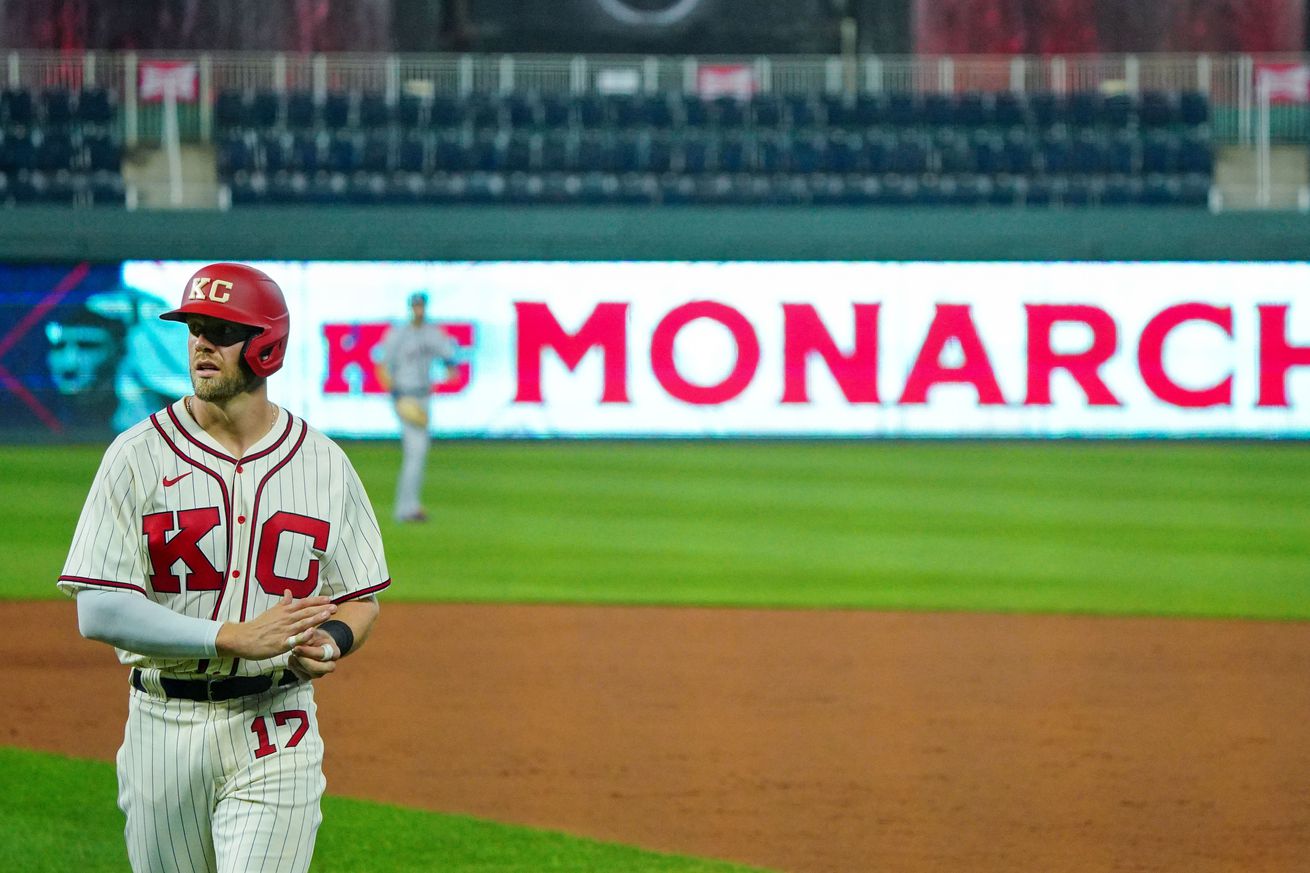 Hunter Dozier, wearing a Monarchs uniform, walks off the field