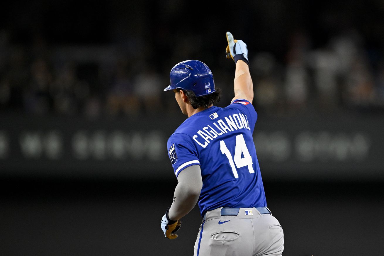 Jac Caglianone, a large lad, raises his right fist into the air and points as he runs the bases.