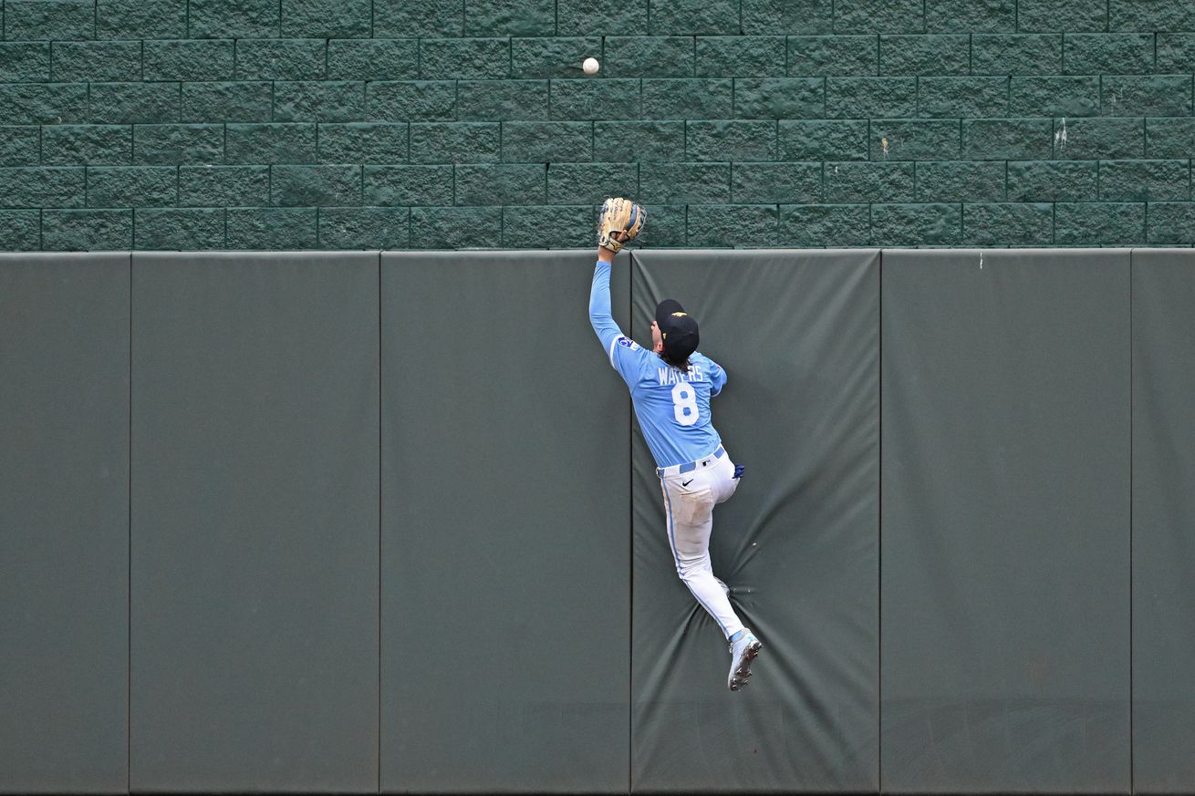 Drew Waters leaps to attempt to catch a home run hit by Will Smith