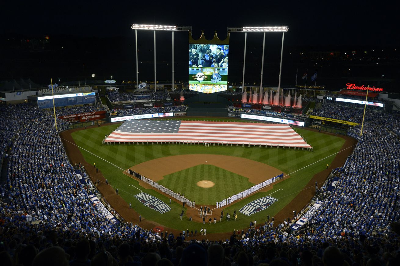 A large flag is unfurled for the singing of the National Anthem before the start of Game 1 of baseball’s World Series at Kauffman Stadium in Kansas City, Mo., on Tuesday, Oct. 21, 2014. (Jose Carlos Fajardo/Bay Area News Group)