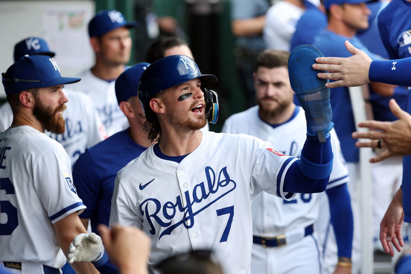 Bobby Witt Jr. #7 of the Kansas City Royals is congratulated by teammates in the dugout after scoring during the third inning of the game against the Pittsburgh Pirates at Kauffman Stadium on July 07, 2025 in Kansas City, Missouri.