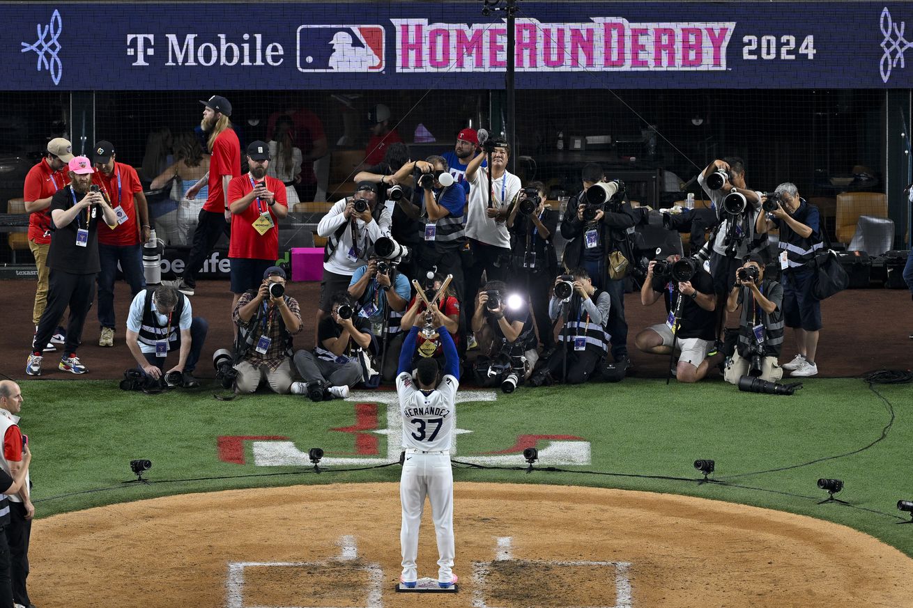 National League outfielder Teoscar Hernandez of the Los Angeles Dodgers (37) poses with the trophy after he wins the 2024 All Star Game Home Run Derby at Globe Life Field.