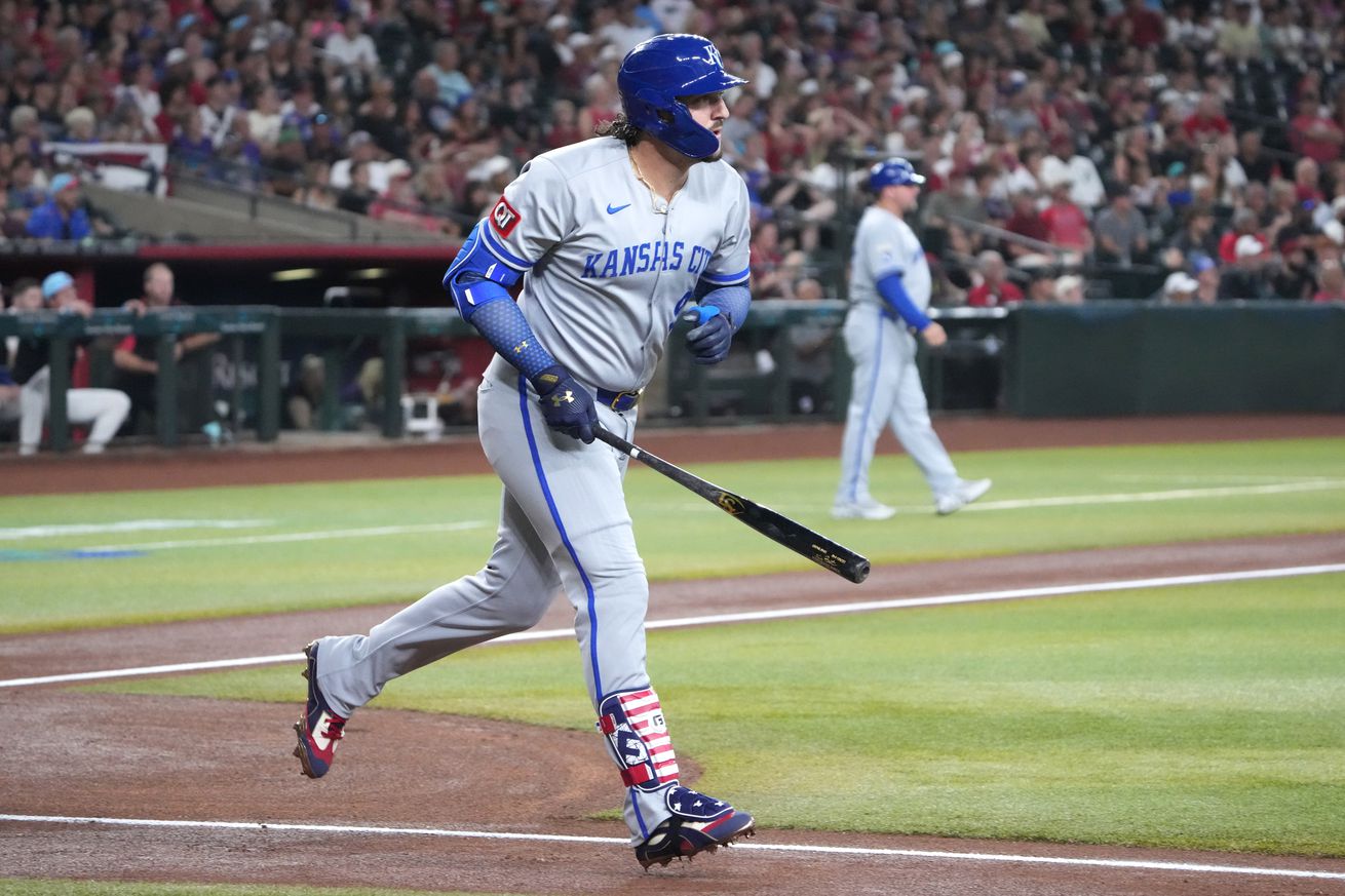 Baseball player Vinnie Pasquantino starts running to first base with his bat in his hand after hitting a home run.