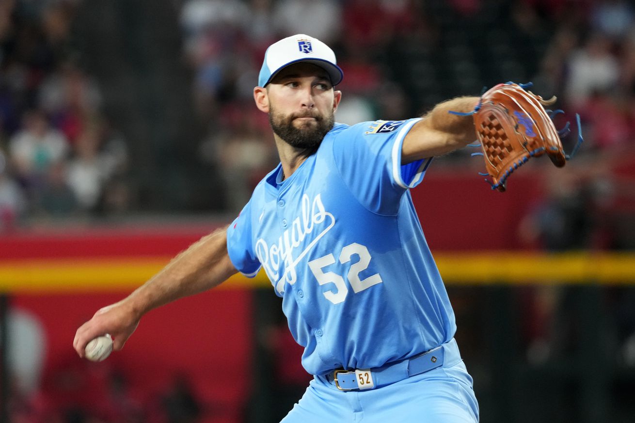 Royals pitcher Michael Wacha rears back to throw a pitch. Relatively close-up view with his glove pointed toward home plate.