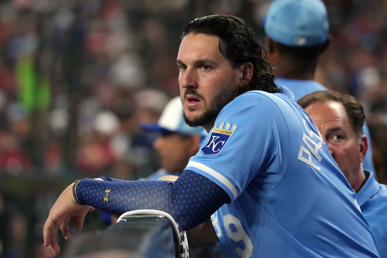 Vinnie Pasquantino watches the game from the dugout fence