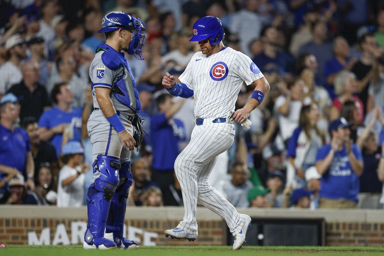 Chicago Cubs catcher Carson Kelly (15) scores against the Kansas City Royals during the fifth inning at Wrigley Field. Mandatory Credit: Kamil Krzaczynski-Imagn Images