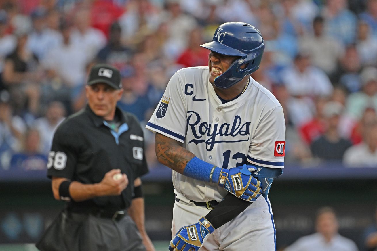 Royals catcher Salvador Perez (13) reacts after getting hit with a pitch in the third inning by Braves starting pitcher Spencer Strider.