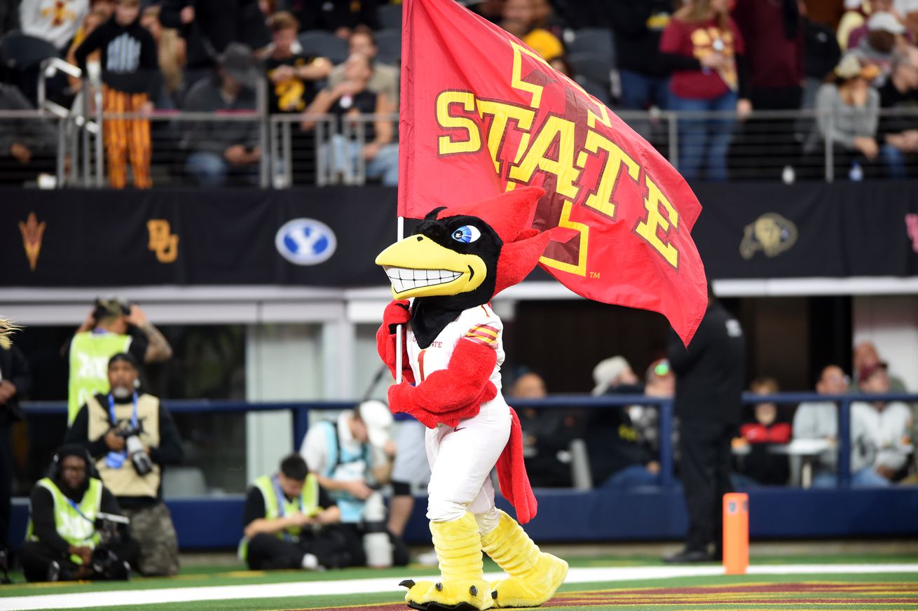 ARLINGTON, TX - NOVEMBER 20: Iowa State Cyclone mascot Cy the Cardinal carries the team flag during the Big XII conference championship game between the Arizona State Sun Devils and the Iowa State Cyclones on December 6, 2024 at AT&T Stadium in Arlington, TX.