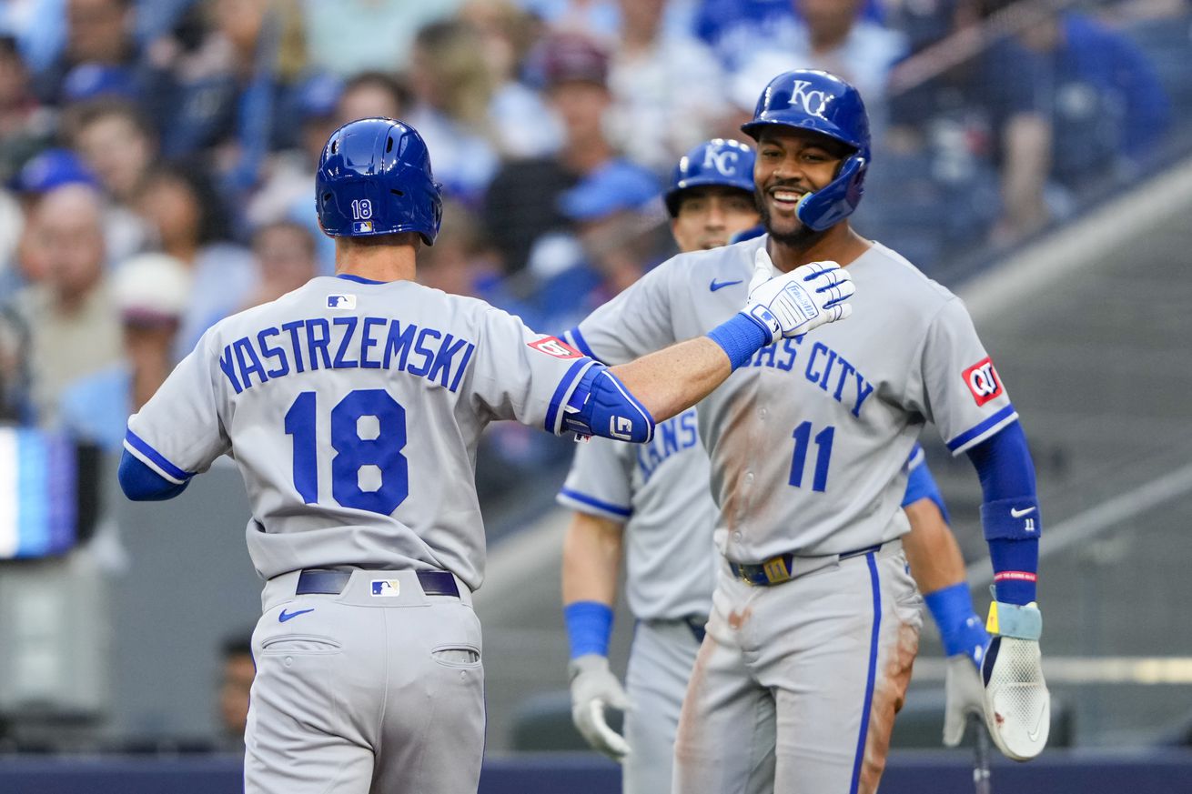 Mike Yastrzemski (18) celebrates with Maikel Garcia (11)